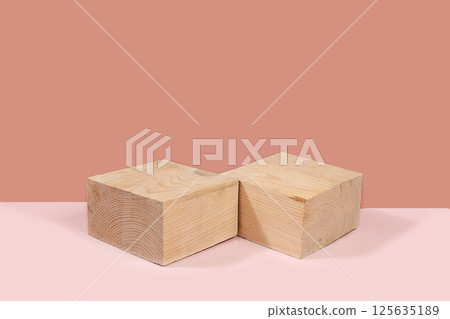 Abstract background with natural wooden podiums and long shadows on a pink wall, an empty showcase for cosmetic products demonstration or presentation, minimal ecology concept, selective focus 125635189