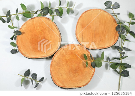 Abstract background with natural wooden podiums and long shadows on a pink wall, an empty showcase for cosmetic products demonstration or presentation, minimal ecology concept, selective focus 125635194