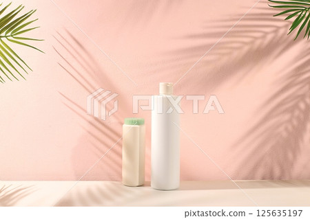 Abstract background with natural wooden podiums and long shadows on a pink wall, an empty showcase for cosmetic products demonstration or presentation, minimal ecology concept, selective focus 125635197