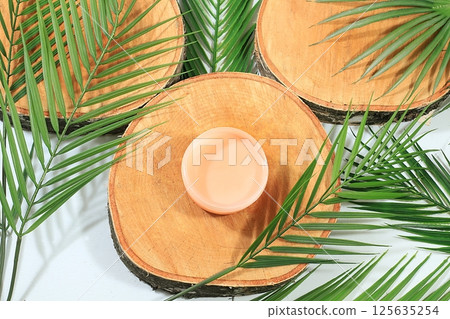 Minimal abstract background for cosmetic products presentation.Empty premium podium with shadows of tropical palm leaves on beige wall,template for design,pedistal display podium,selective focus Minimal abstract background for cosmetic products presentation.Empty premium podium with shadows of tropical palm leaves on beige wall,template for design,pedistal display podium,selective focus 125635254