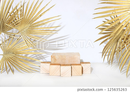 Minimal abstract background for cosmetic products presentation.Empty premium podium with shadows of tropical palm leaves on beige wall,template for design,pedistal display podium,selective focus 125635263