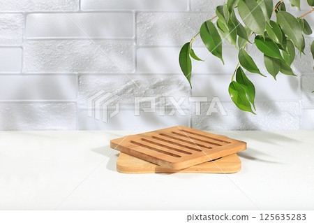 Minimal abstract background for cosmetic products presentation.Empty premium podium with shadows of tropical palm leaves on beige wall,template for design,pedistal display podium,selective focus 125635283