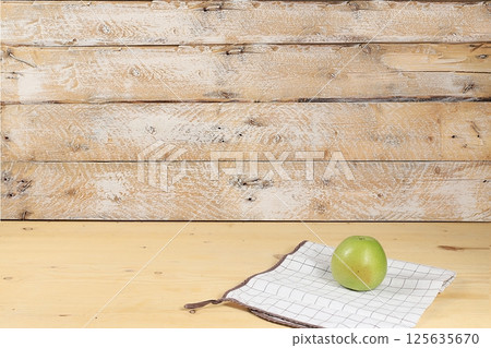 Empty wooden table with green apple on old background with place for text, rustic style, healthy lifestyle and weight loss concept, mock up for design and showcase for product demonstration, selective Empty wooden table with green apple on old background with place for text, rustic style, healthy lifestyle and weight loss concept, mock up for design and showcase for product demonstration, selective 125635670