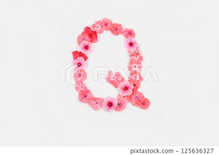 A letter Q made from real fresh flowers. Creative floral font concept. Unique collection of letters and numbers for design. Spring, summer, autumn and valentines, creative idea, selective focus A letter Q made from real fresh flowers. Creative floral font concept. Unique collection of letters and numbers for design. Spring, summer, autumn and valentines, creative idea, selective focus 125636327
