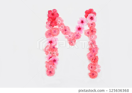 Letter M made from real fresh flowers. Creative floral font concept. Unique collection of letters and numbers for design. Spring, summer, autumn and valentines, creative idea 125636368