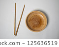 Wooden chopsticks and wooden bowls, highlighting sustainable tableware 125636519