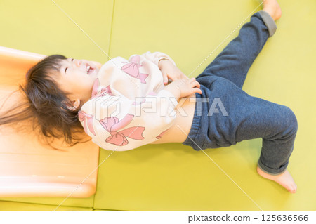 Japanese girl playing on a slide 125636566