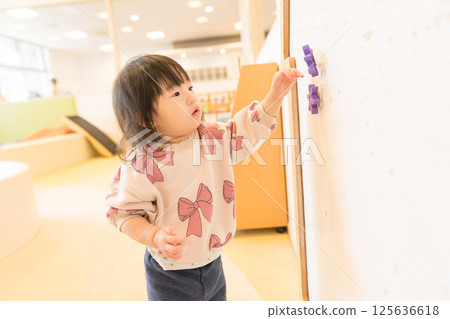 Japanese girls playing in the kids room 125636618