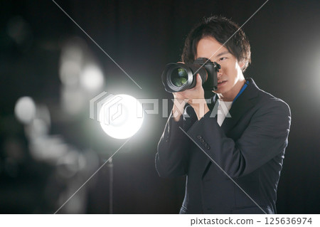 Male photographer taking a photo 125636974