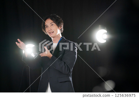 Male photographer taking a photo 125636975