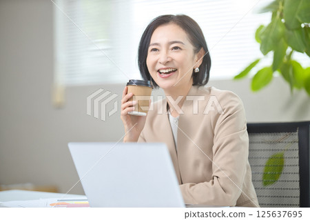 Middle-aged woman having a meeting in the office Middle-aged woman having a meeting in the office 125637695