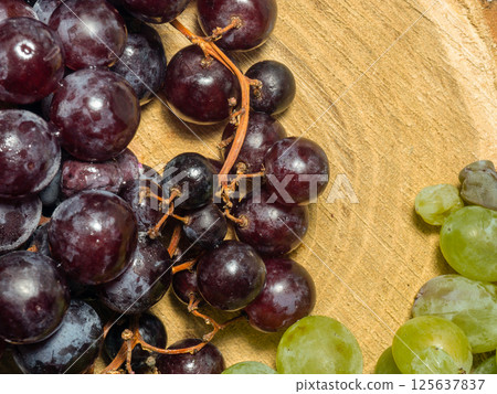 Grapes kishmish on a wooden background. The grapes are overripe. Harvest in the village 125637837