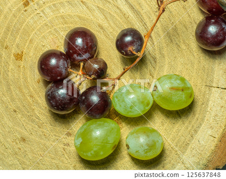 Grapes kishmish on a wooden background. The grapes are overripe. Harvest in the village Grapes kishmish on a wooden background. The grapes are overripe. Harvest in the village 125637848