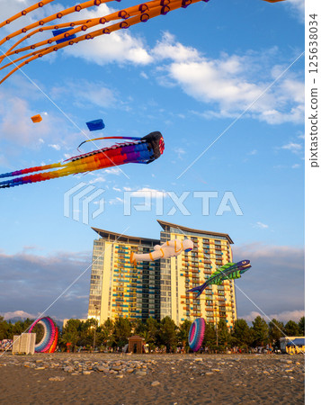 Kite Festival. Kites in the sky. A spectacle . Wind is like a force. air objects. Various forms. A beautiful sight. Aerodynamics. Object in the sky. Holiday on the beach Kite Festival. Kites in the sky. A spectacle . Wind is like a force. air objects. Various forms. A beautiful sight. Aerodynamics. Object in the sky. Holiday on the beach 125638034
