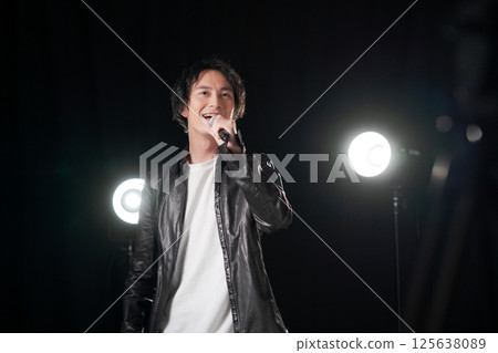Musician singing a song Musician singing a song 125638089