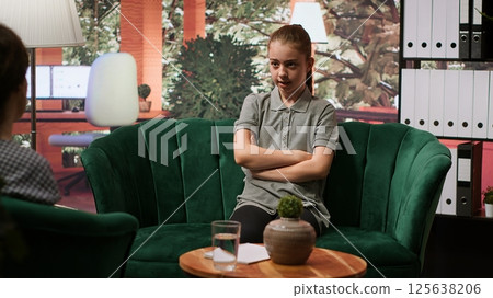 Adolescent undergoing behavioral therapy to address anxiety and social issues. Session with an expert focuses on emotional management while addressing cyberbullying. Troubled teen. Camera A. 125638206