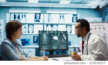 Doctor highlighting dosage of vitamins and painkillers on medical prescription, explaining the instructions and in order to recover quickly. Modern healthcare services. Camera B. Doctor highlighting dosage of vitamins and painkillers on medical prescription, explaining the instructions and in order to recover quickly. Modern healthcare services. Camera B. 125638237