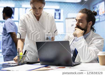 Medical staff collaborates on diagnostic procedures and treatment plans. Radiology specialists work on accurate diagnosis and effective disease prevention, healthcare industry insurance. Medical staff collaborates on diagnostic procedures and treatment plans. Radiology specialists work on accurate diagnosis and effective disease prevention, healthcare industry insurance. 125638329