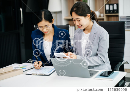 Working team meeting concept, Asian business using laptop and smart phone and digital tablet computer with digital marketing media in virtual icon Working team meeting concept, Asian business using laptop and smart phone and digital tablet computer with digital marketing media in virtual icon 125639996