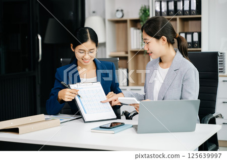 Portrait of success business people working together in office. Couple teamwork startup concept Portrait of success business people working together in office. Couple teamwork startup concept 125639997