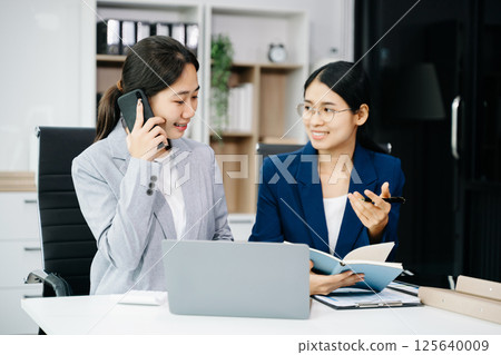 Kind leader executive manager share and discuss business solutions plan ideas on tablet with Asian female marketing manager Kind leader executive manager share and discuss business solutions plan ideas on tablet with Asian female marketing manager 125640009