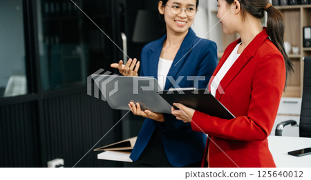 Kind leader executive manager share and discuss business solutions plan ideas on tablet with Asian female marketing manager 125640012