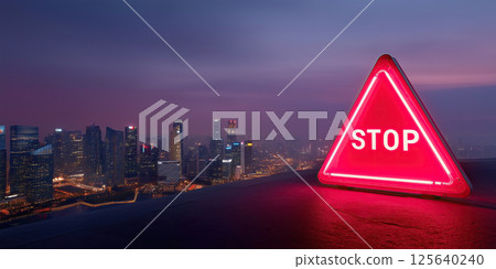 Cityscape at night with neon stop sign, modern skyline, urban atmosphere, glowing warning 125640240