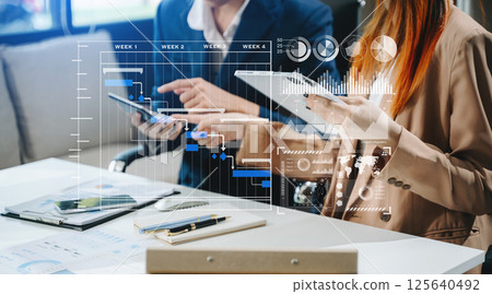 Business team hand Project manager working and update tasks and Gantt chart scheduling virtual diagram. 125640492