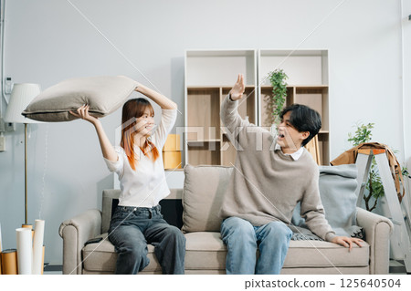 Happy asian young attractive couple man and woman with big boxes moving into a new house, new apartment for couple 125640504