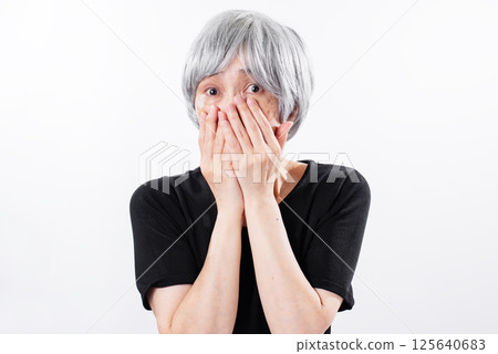 Senior woman hiding her face with her hands 125640683