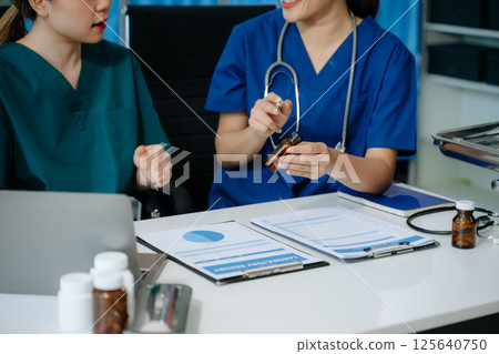 Doctors and nurses collaborate on medical treatment and prescription plans, analyzing data Doctors and nurses collaborate on medical treatment and prescription plans, analyzing data 125640750