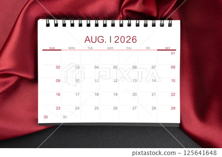 August 2026 Monthly desk calendar with red silk on black leather background. August 2026 Monthly desk calendar with red silk on black leather background. 125641648