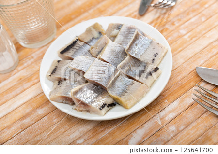 Pieces of chopped herring served on plate Pieces of chopped herring served on plate 125641700