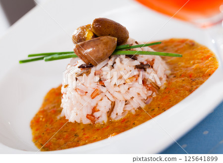 Roasted chicken hearts served with rice and creamy tomato sauce Roasted chicken hearts served with rice and creamy tomato sauce 125641899