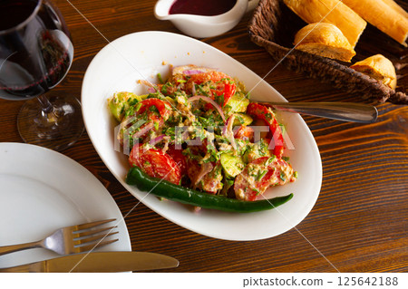 Fresh vegetable salad in Georgian style with walnut dressing Fresh vegetable salad in Georgian style with walnut dressing 125642188