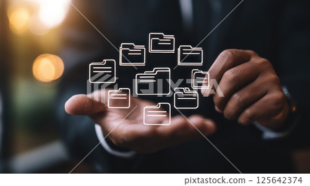 Business Professional Managing Digital Documents with Floating Folder Icons in Modern Office Setting 125642374