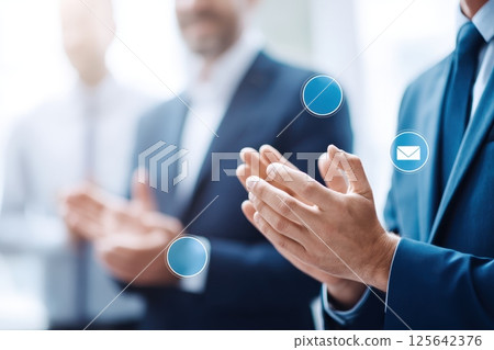 Business Team Leaders Shaking Hands While Colleagues Applaud in an Office Setting 125642376