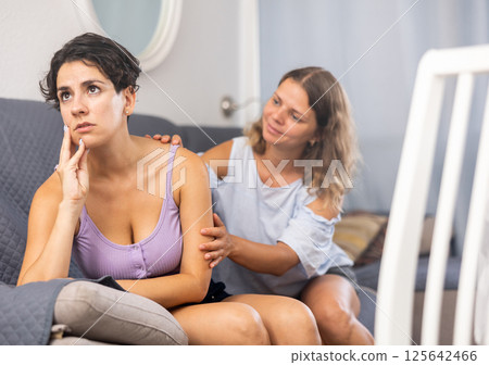 Beautiful girl keep arms folded, do not talk to her friend 125642466