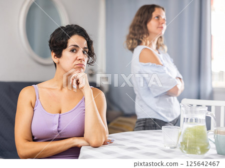 Offended girlfriends ignoring each other after quarrel 125642467