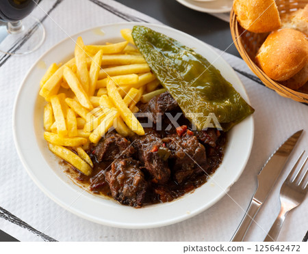 Veal stewed in red wine 125642472
