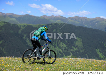 Riding mountain bike in the beautiful mountains 125643331