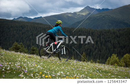 Riding mountain bike on beautiful forest mountain top 125643347