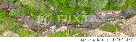 Drone view above people sliding in the Devils Bathtub waterfall and pool in Spearfish Canyon, South Dakota 125643377