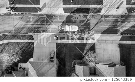 Aerial view above a garbage truck in a residential suburban area in fall morning 125643399