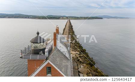 Rockland Breakwater Lighthouse cutting through the harbor on the Gulf of Maine  125643417