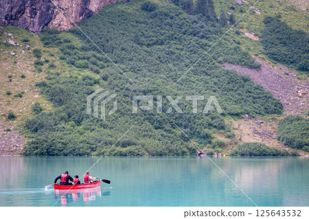 Tourists using a rented canoe in Lake Louise, Alberta, Canada Tourists using a rented canoe in Lake Louise, Alberta, Canada 125643532