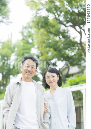 Middle married couple cuddling with smile Middle married couple cuddling with smile 125643550