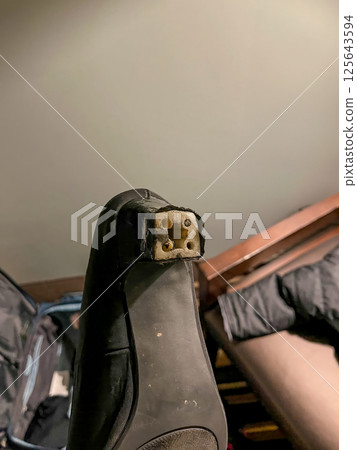 Broken high heel on a woman's black dress shoe 125643594