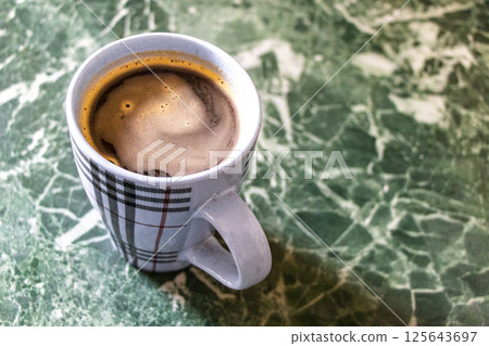 Coffee cup on marble table background in Brest Belarus. Coffee cup on marble table background in Brest Belarus. 125643697