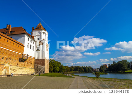 Mir Castle majestic fortification fortress Park monument with lake Belarus. 125644178